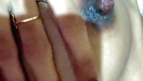 Solo female is on her bed in a masturbation session