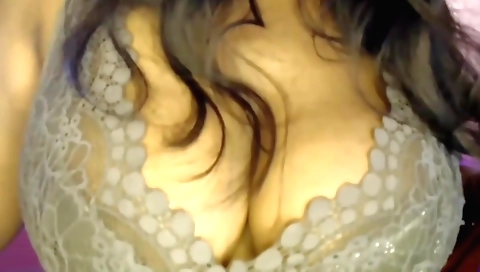 Busty brunette in hot stockings is teasing her boobs