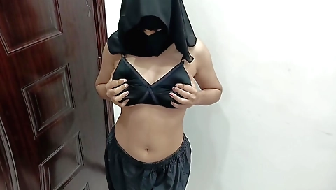 Curvy desi in sexy earrings takes photos in front of a camera