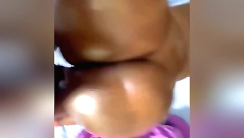 Big booty girl sucks a large condom in a doggy position