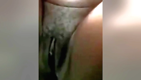 Indian woman with a hairy pussy masturbating in a room